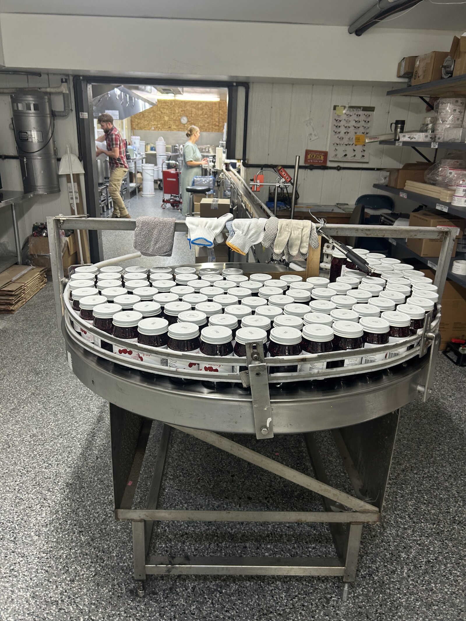 Fresh jars of jam coming off the bottling line