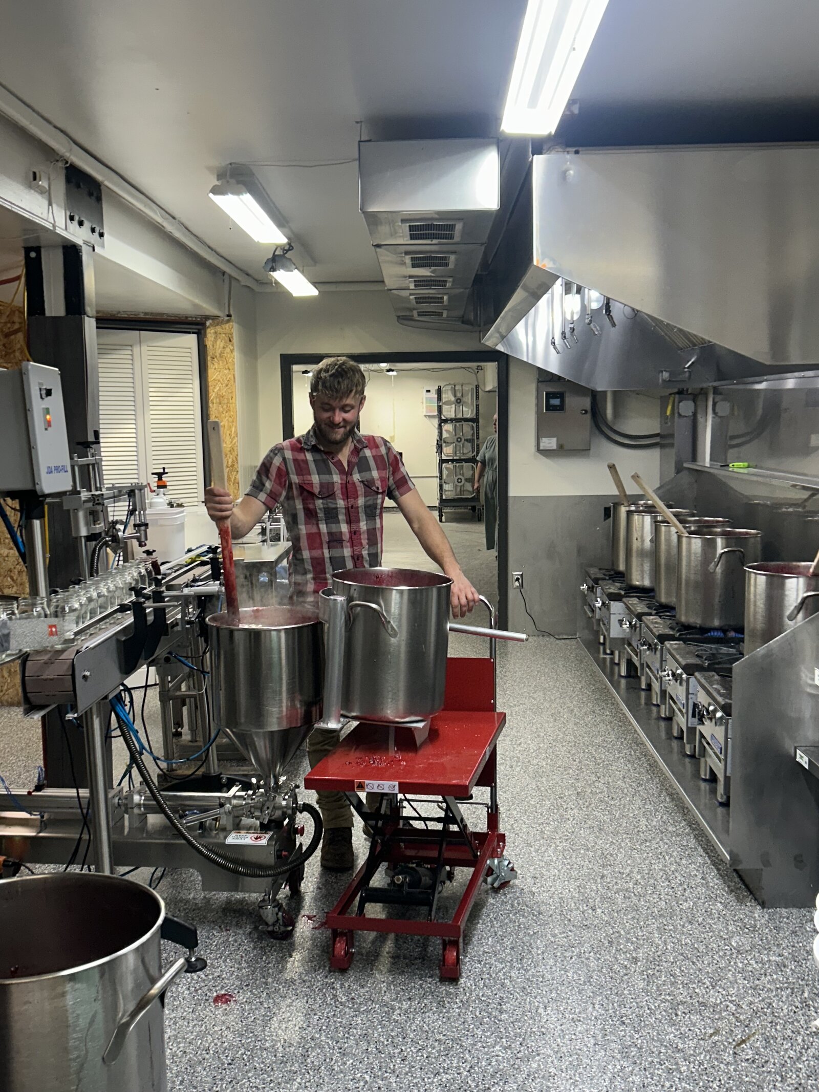 Stirring a kettle of jam in the Keweenaw Kitchen