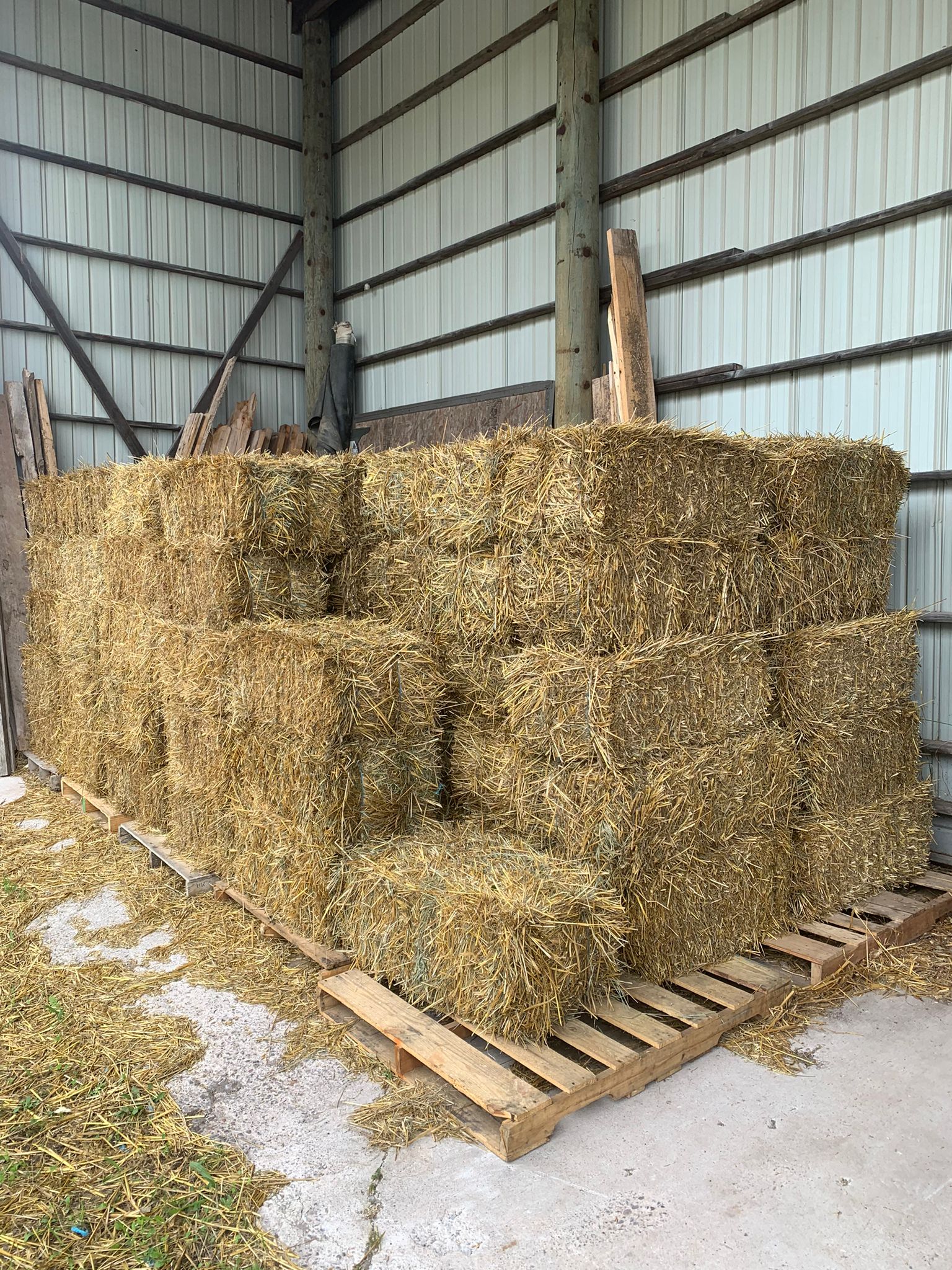 Bales of straw and bags of livestock feed